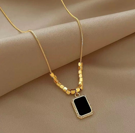 Elegant Gold Necklace with Black Rectangular Pendant