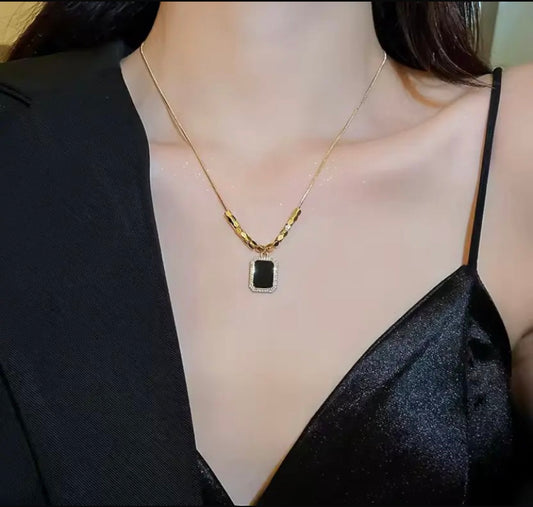 Elegant Gold Necklace with Black Rectangular Pendant