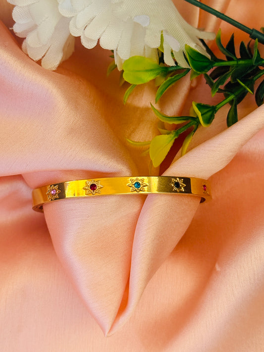 Elegant Gold Bangle with Multicolored Gem Accents