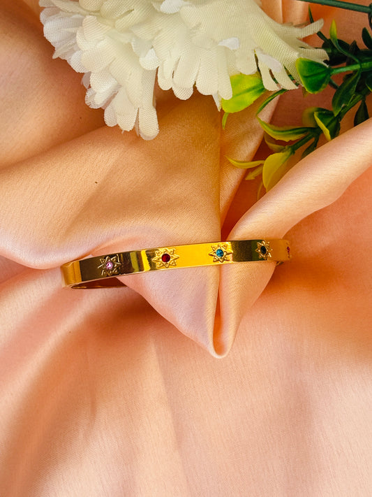 Elegant Gold Bangle with Multicolored Gem Accents